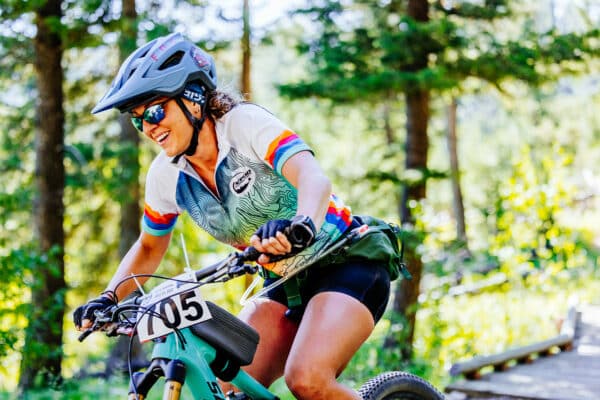 Butte photography of Butte 100 racer smiling while riding bike