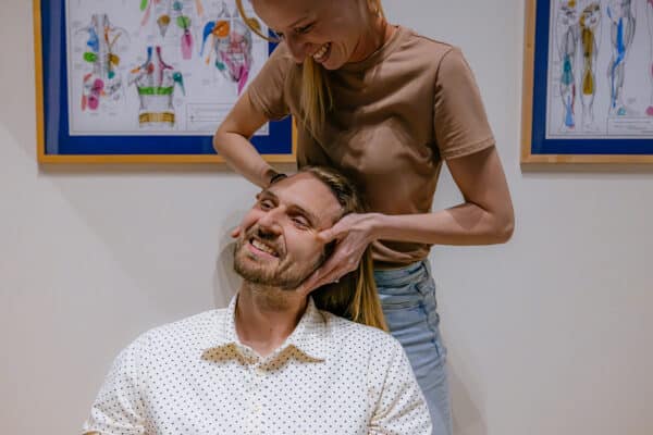 Brand photography capturing a chiropractic adjustment in progress at a clinic in Butte, Montana.