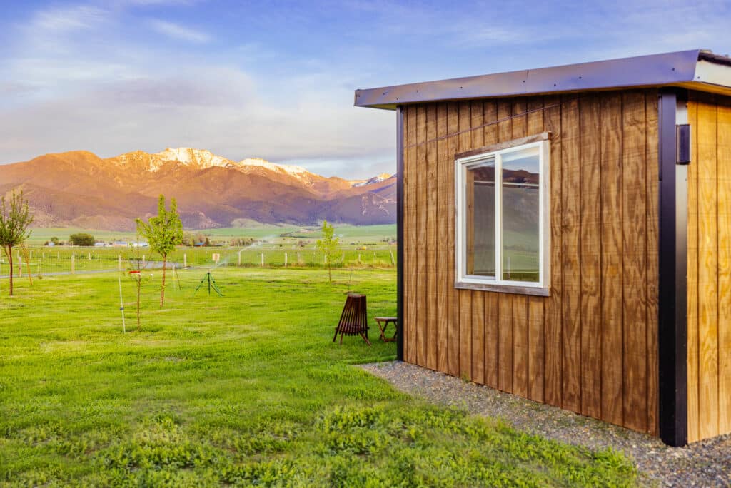 Montana Airbnb Photography showing modern cabin featuring a beautiful mountain scene at sunset