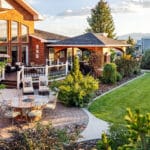 Large-scale residential landscape design with garden zones and outdoor dining area in rural Montana