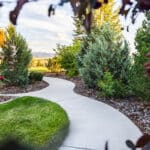 Organic garden pathway with established plantings at a rural Montana residential landscape