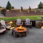 Outdoor fire pit with surrounding stone landscape design at a modern Montana residence