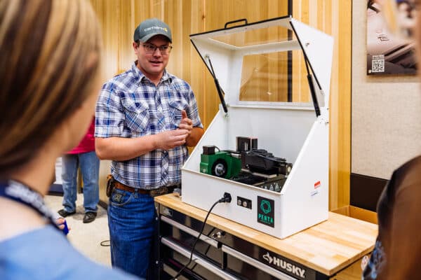 STEM instructor presents robotics technology to students during an educational event in Montana.