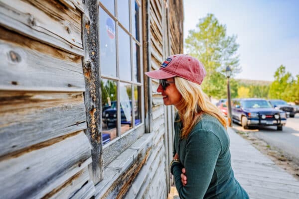 Women looking through window of historic building in Virginia City