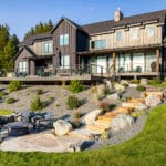 Stepped stone terraces with native plantings at a modern residential landscape design