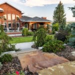 Stone entry steps with plantings leading to a rural Montana residence