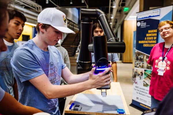 Student concentrates while learning robotics skills at a hands-on STEM event in Bozeman, Montana.