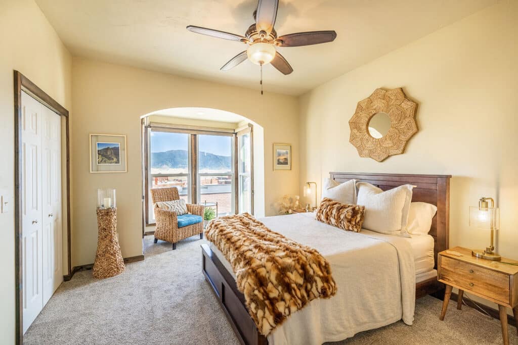 Montana vacation rental bedroom photographed with natural light and balanced window exposure.